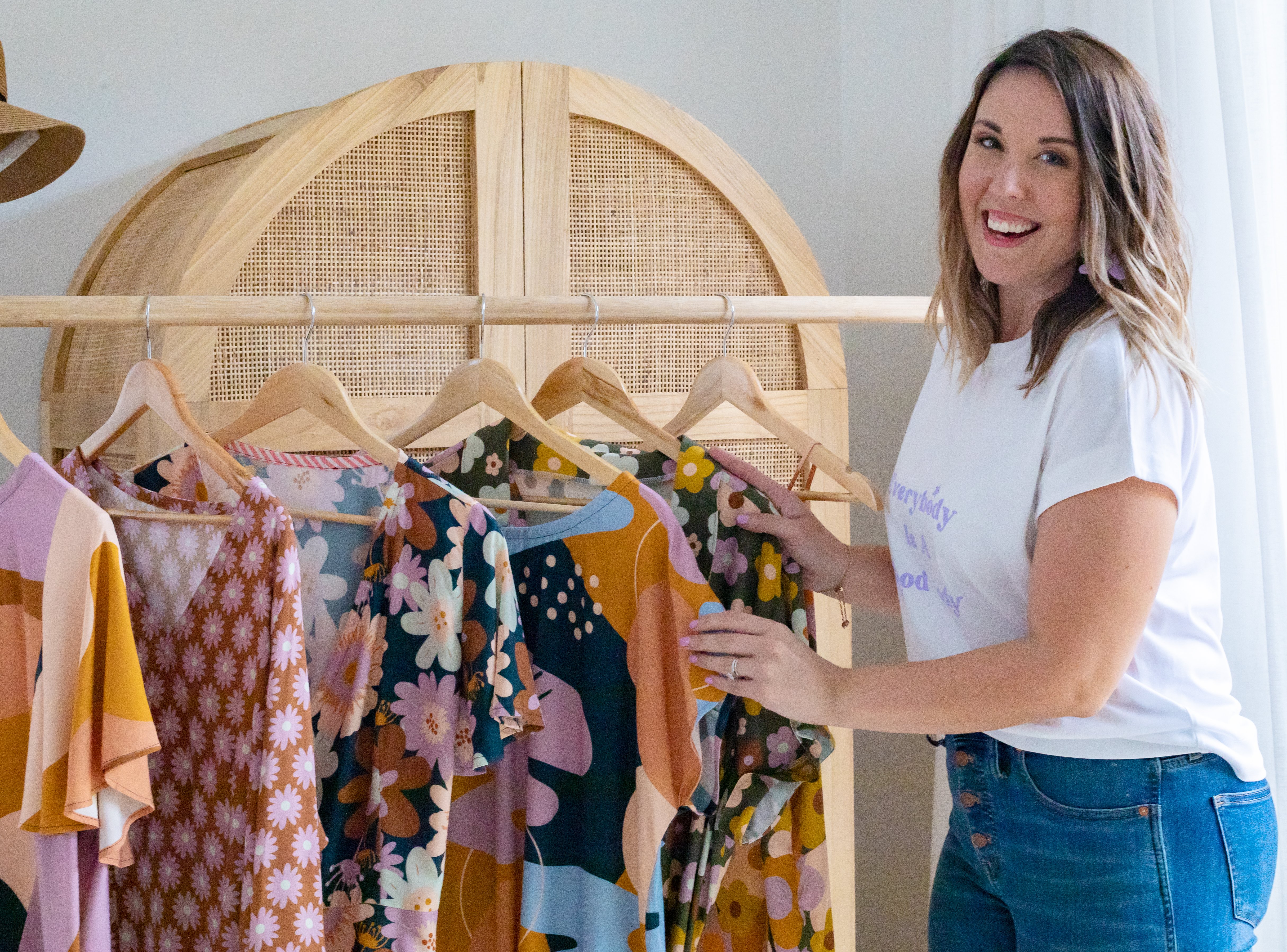 Lindsey, the creator behind sewing brand Sew to Grow is standing in front of her designs.